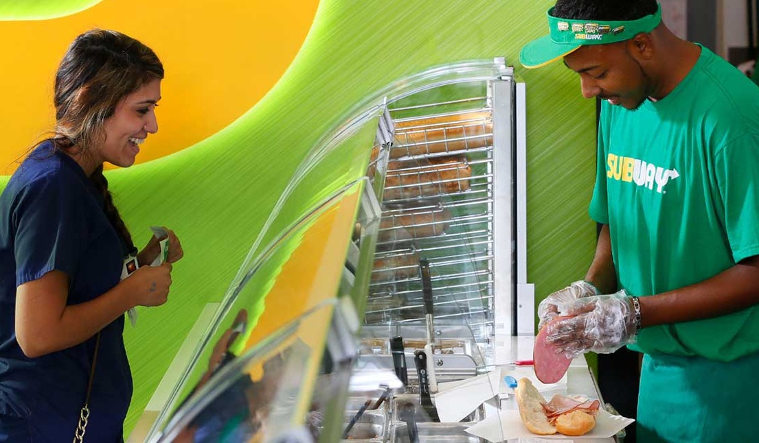 Employees at Subway sandwich counter